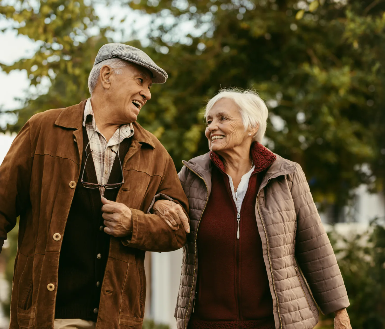 Older couple walking together outside.